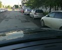 Убитая дорога, подъезд к ИФНС Кировского района. Сотни жителей ежедневно приезжают, а тут яма на яме