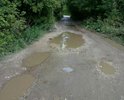 Отсутствие асфальтированной дороги в поселок Михалково. Ситуация усугубляется с наступлением сезона дождей: дорога все больше размывается и затрудняет движение автомобилей и пешеходов
