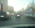Дорожное движение организовано на данном перекрёстке ужасно, из-за чего на этом месте всегда пробка.
Два варианта решения:
1. Запретить поворот налево при движении из Москвы. Не самое удачное. Ибо тогда надо будет организовать разворот максимально близко после поворота. Иные решения не будут должным образом исполняться участниками дорожного движения, что приведёт к увеличению мелких ДТП.
или
2. Изменить правила проезда по полосам:
2.1. Движение из Москвы:
2.1.1. Крайнюю левую полосу сместить на 1,5-2м влево начиная за 300 метров до стоплинии, 
2.1.2. Разрешить с крайне левой полосы только поворот налево под стрелку в дополнительной секции, вторая полоса (слева на право по ходу движения) только для движения прямо и третья полоса (с лева на право по ходу движения), разрешить движение прямо и направо (т. к. дополнительной секции для поворота направо нет, это не будет создавать затруднения в движении).
2.2. Движение в сторону г. Москва:
2.2.1. Добавить разметку предупреждающую водителей о смещении левой полосы вправо (как это сделано на перекрёстке с ул. Чикина).
2.2.2. Установить знак 5.15.1 "Направления движения по полосам" с указанием смещения полос вправо и правила проезда перекрёстка.