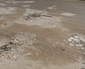 На отмеченном участке большие ямы глубиной более 10 см, шириной более 60 см, длиной более 50 см, размеры которых превышают предельно допустимые значения в соответствии с требованиями ГОСТ Р 50597-93 «Автомобильные дороги и улицы», дорога вся в выбоинах. После дождя дорога превращается в глубокое озеро. Ранее машины из двора дома 7а выезжали в город по единственной асфальтированной дороге через дворы домов 3а,5а,7. Дорога же ЗА этими домами не была предназначена для автотранспорта. Несколько лет назад собственники домов 3а,5а,7 перегородили для выезда из двора дома 7а асфальтированную дорогу внутри своих дворов бетонными полусферами. Для жителей дома 7а выезд из своего двора остался по неразработанной дороге ЗА домами 3а,5а (отмеченный участок на карте). При этом эта дорога умещает на себе один автомобиль. Разъезжаются машины , заезжая на кусты, чем портят покраску своих машин и озеленения. После неоднократного письменного обращения в ГИБДД, нам отвечали, что дороги за домами 3а,5а нет на плане города, поэтому ремонтировать ее не будут. Жители дома 7а остались без дороги.
Так же испорчена за 20 лет дорога внутри двора.