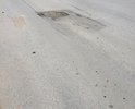 Центральная улица города, после зимы на латке образовалась глубокая яма, латка под тяжестью большегрузным машин просела.