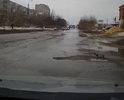 Улица Попова, множество ям- очень глубоких, скрытых под водой.