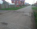 На данном участке дороги наблюдаются отдельные повреждения дорожного полотна (выбоины, трещины, деформации и разрушения), а также систематическое скопление дождевых вод (существующий ливнесток в виде металлической трубы с отверстиями не эффективен).
