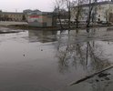 Покрытие улицы разрушено полностью, на улице много луж под которыми большие ямы.