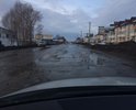 Одна из самых больших улиц города, постоянно в воде и ямах, скрывающих половину колеса легкового автомобиля.