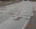 Одна из центральных улиц города, которая берет своё начало у въезда в город и ведет в центральную часть города.Состояние дорожного полотна видно на фотографиях. Скорость движения по этому участку не может превышать порой и 10 км/ч, так как если двигаться с разрешенной скоростью 60 км/ч, есть возможность не справиться с управлением, либо причинить вред т/с, а именно "убить"элементы подвески, погнуть диски, лопнуть шины и др. Ямочный ремонт является неэффективным и  решением проблемы лишь на некоторое время. Хочется отметить, что после проведения ямочного ремонта дорога все равно продолжает напоминать стиральную доску из года в год.