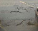 Сегмент дорожного полотна улицы Жуковского между улицами Луначарского и Гоголя имеет массу дефектов: ямы, выбоины, проваленные или чрезмерно возвышающиеся над плоскостью дороги канализационные люки.