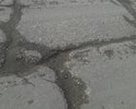 Состояние дороги просто ужасное. Ездить невозможно. Автомобилисты ездят по обочине, а правила дорожного движения это запрещают. А как еще ездить? Камазисты со своими колесами всю дорогу разбомбили. В прошлом году отремонтировали участок в метров 200-300 и на этом все. Можно подумать большое дело сделали. А эти 200-300 метров погоды не сделали. С каждым годом состояние дороги просто ухудшается. Можно сказать, что ее совсем нет. И эта вся дорога такая, как на фото. Отремонтируйте пожалуйста, ездить ведь невозможно.