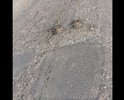 Неровная дорога с ямами и латками, если обратить внимание на люк сразу бросается в глаза, что люки это конек дорожников города Каспийска , а в данном случае они превзошли сами себя