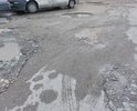 Дорога, проходящая вдоль дома по ул. 60-летия Октября 24 с такими глубокими ямами, что водители, после дождя, не зная глубины ям, "оставляют бамперы". Пройти пешком, не говоря уже о коляске с ребёнком - просто невозможно, а в дождь даже в сапогах не проплыть!!!