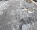 Дорога, проходящая вдоль дома по ул. 60-летия Октября 24 с такими глубокими ямами, что водители, после дождя, не зная глубины ям, "оставляют бамперы". Пройти пешком, не говоря уже о коляске с ребёнком - просто невозможно, а в дождь даже в сапогах не проплыть!!!