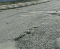 Ужасное состояние проезжей части дороги по ул Забалуева на участке от 1-го до 12-но переулков Порт-Артурских.тротуары отсутствуют. Дорога вся разбита.