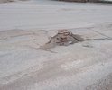 Участок от перекрёстка Космонавтов-Дзержинского до моста, с обеих сторон крайние полосы (Ямы, и кирпич). Кирпич - не является асфальтом. Наличие ям с глубиной в ширину кирпича - не является нормой.
