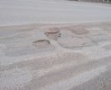 Участок от перекрёстка Космонавтов-Дзержинского до моста, с обеих сторон крайние полосы (Ямы, и кирпич). Кирпич - не является асфальтом. Наличие ям с глубиной в ширину кирпича - не является нормой.