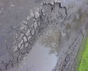 Из-за камазов едущих в Кошелев дорога стала невыносимо грязной и покрылась сплошными ямами.