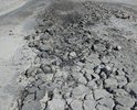 Участок асфальтированной автодороги полностью рассыпался на дыры , а так же из за поломок асфальтоукладчика , асфальт уложен как  на стиральной доске , то есть при движении автомашины со скоростью более 40 км. в час авто подпрыгивает, на участке длиною 3 км. нет указателей"Подпригивающая автодорога " не соответствующая гост .Нет знаков , что есть выбоины и ямы