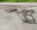 Разбитая дорога на повороте с ул. Спичечная на ул. Августовская