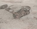 Разбитая дорога на повороте с ул. Спичечная на ул. Августовская