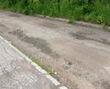 Разбита дорога на съезде с ул. Большая Прорубная к гаражам напротив дома 16 на ул. Сухова