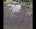 Огромная яма с не просыхающей лужей.