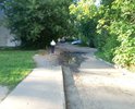 Огромная яма при въезде во двор. Въезд машинам затруднён. В яме всегда скапливается вода и грязь. Яме уже более 2-х лет. С каждым годом её размывает все глубже и шире. Так же пострадал тротуар вдоль этой дороги.
