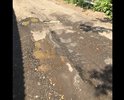 Убита дорога , недавно был выполнен "ямочный ремонт" для галочки (с наглядными нарушениями ), но на дороге как были ямы так и остались. Помимо этого дорогу регулярно затапливает после дождей , что наглядно видно на фото. Дорога находиться на улице Светлая в селе Ромашково, просьба полностью поменять покрытие асфальта на данном участке дороги.