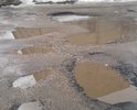 Этот участок не ремонтировался со времени постройки этой автодороги. два раза в год грейдером подравнивают, но это не решает проблему, через неделю все ямы вновь появляются на своих местах. Ямы глубиной более 15 см.