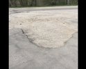 Ямы находятся на улице, которая ведёт к фирме «Блеск», занимающейся ремонтом дорог в городе. Яма на фото расположена прямо перед въездом в эту организацию