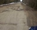 На дороге имеются многочисленные повреждения дорожного полотна. Повреждения в виде ям по всей поверхности дорожного полотна. Ремонт дороги в этом направление не производился очень много лет. Дорога является единственным связующим звеном между деревнями и районным центром.