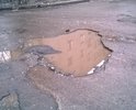 Дорога с глубокими ямами на ул.Саврасова д.22, 24, 26а. Просим ремонт дороги!!!