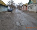 Участок дороги с выбоинами на повороте ул. Гилянская, 70, напротив продуктового магазина "Алиса".