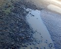 Дорожное полотно по улице Ракетчиков, начиная со съезда с М-1, находится в ужасном состоянии. Ближе к М-1 дорогу разбивают грузовики со стройки, чуть дальше ямы, которым уже как минимум 2 года. В дождь ямы заполнены водой - они становятся менее различимы и если попасть, то можно повредить шину, диск, элементы кузова и подвески а/м. 
Кроме того, проезжая часть покрыта грязью и не производится ее уборка. 

На этом участке не обеспечен водоотвод, поэтому во время осадков большие лужи просто скрывают ямы и их невозможно заметить и распознать.
Машины стараются объехать ямы и справа или слева, маневрируя по всей ширине проезжей части. Требуется отремонтировать дорожное полотно.
 
Пешеходы вынуждены передвигаться по проезжей части, т.к. на этом промежутке тротуарная часть присутствует частично, там где присутствует, она рассчитана только на одного человека - два человека не помещаются. К тому же в темное время суток улица освещается плохо и пешеходов не видно. Все это (увиливание от ям, отсутствие тротуара (узкий тротуар), плохое освещение) создает угрозу жизни и здоровью пешеходов, и угрозу поломки автомобилей. В этом году прошло заселение ЖК Одинцово-1 и количество пешеходов много кратно увеличилось, включая женщин с колясками. Требуется организовать тротуар со съездами с него в местах выезда из придомовой территории, а также расширить уже имеющиеся участки.

Кроме того, т.к. улица освещена плохо, на этом промежутке расположены ИН (лежачие полицейские), но на поверхность ИН НЕ нанесены световозвращающие элементы, поэтому в темноте их не видно. Высота ИН превышает 7 сантиметров. Требуется организовать ИН согласно ГОСТ.