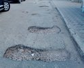 Часть дороги дублера, у Новуса на пр-те Октябрьской Революции. Дорога разбита и в ямах.