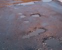На данном участке дороги по улице Сутырина никакого ямочного ремонта не осталось и в помине, такое же состояние и у стоянки напротив Адмирала. Сплошные ямы и месиво из грязи.