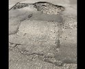 Разбитый асфальт и глубокие ямы на территории ГИБДД Рязани