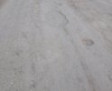 Разбитая улица в черте города.на работу невозможно ездить.местами глубокие ямы.г.Валуйки, недалеко от улицы Суржикова.на карте отметил.