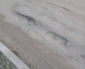 Разбитая улица в черте города.на работу невозможно ездить.местами глубокие ямы.г.Валуйки, недалеко от улицы Суржикова.на карте отметил.