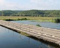 Требуется построить новый бетонный мост через реку Оскол. Осенью и зимой река разливается и затапливает деревянный мост, проезд через реку становится невозможен.Дорога после моста требует ремонта.Так же требуется провести освещение,на этом участке.