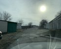 В городе-герое Новороссийске Краснодарского края на проезжей части в районе дома № 2 по пер. Краснознамённому рядом с гаражами имеются дефекты дорожного покрытия, не соответствующие требованиям ГОСТ Р 50597-2017. Пожалуйста, примите меры к ремонту дороги.