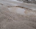 Требуется срочный ремонт дороги, ездить невозможно!!! Размеры ям превышают нормы в несколько раз. По  этой улице проходит большой поток грузового транспорта, отсюда и результат.