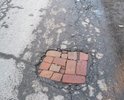 Множественные ямы. Провели ремонт в переулке, по самым современным технологиям. Асфальтный завод проиграл, кирпичный выиграли тендер на работы в нашем городке.