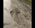 Дорога в колеях и часто под водой на яме на 1 фото часто пробивают шины и на въезде во двор игдустриальна 1 б большая яма прошу содействия в ремонте.