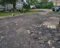 Дорога у площадки ТКО и территория за самой площадкой. Пару десятков лет назад большое пространство перед площадкой ТКО (на первом фото) было асфальтировано. Асфальт со временем пришел в негодность, ремонтные работы на этом участке никогда не проводились, хотя это одна из дорог к 1 школе, к техникуму, проезжая часть и по совместительству подход к площадке ТКО. Недавно участок перед ТКО и за площадкой ТКО посыпали асфальтобетонным ломом, как временное решение. Просим организовать укладку асфальта на этой проезжей части, перед ТКО и убрать остатки асфальтобетоного лома за ТКО, асфальтировав пространство вокруг мусорной контейнерной площадки.