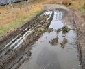 Улица Подгорная. Жжелезнодорожный переезд под насыпью для легковых авто. Так как грейдер не может пройти под переездом улица не грейдеруется очень долго. Грунт. Мелкий камень, глина и почва. Ямы, канавы, колея частая. Частично есть супесь. Улица находится за железнодорожной насыпью. Покрытия нет вообще. Является жилой. Рядом расположена станция и магазины. Знаков нет. Необходима осыпка улицы и формирование дорожной подушки. Уместно все укласть бетонными плитами. Есть взгорки и уклоны, частично есть кустарник. местность неровная с сильными перепадами так как находится перед сопками. Возможно необходимо или углубить проезд для автомобилей то есть реконструировать для проезда грузовых авто чтобы грейдер мог по кратчайшему маршруту пройти под насыпью. Необходим ремонт проезда под насыпью укрепление по сроку эксплуатации.