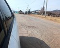 Республика Бурятия, село Кома, ул. Коммунистическая.
Дорога очень изношена, ямы, выкрашивание асфальта, промята колея. Нет тротуаров и площадок, подъездов у социальных объектов.