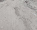 На фото видно, что водой вымыло плиты и кирпичи, которые были засыпаны песком, сейчас они торчат и опасны для машин. Когда идет дождь в данном месте образуется огромная лужа. Просьба произвести отсыпку песком отмеченного участка дороги.