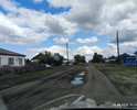 Центральная улица, деревня Север,
Чановский р-н 
Новосибирская обл.
Большие ямы (на фото - заполненные после дождя).
Асфальт, который тут когда то давно был, отсутствует