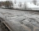 Ямы глубиной 10 - 20 см. Через всю проезжую часть.