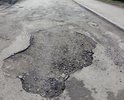 АКСАЙ, РОСТОВСКАЯ ОБЛАСТЬ. Разбитое дорожное полотно переулок Степной. Радом с Пересечением с ул.Садовой ДОМ 2.