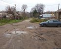 Страшно "убитая" дорога. Нет возможности пройти и проехать. Огромные ямы, грязь, и лужи.